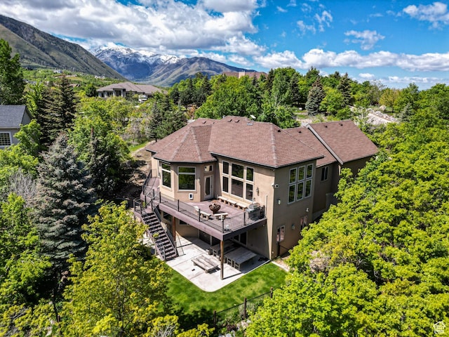 740 S Oak Dr, Woodland Hills, UT 84653 - rear view of house featuring stairway, a deck with mountain view, stucco siding, a patio, and a shingled roof