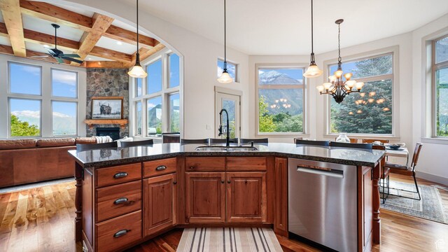 740 S Oak Dr, Woodland Hills, UT 84653 - kitchen featuring dishwasher, a sink, a stone fireplace, dark wood-style floors, and dark stone countertops