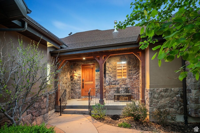 740 S Oak Dr, Woodland Hills, UT 84653 - doorway to property featuring stone siding, stucco siding, covered porch, and a shingled roof