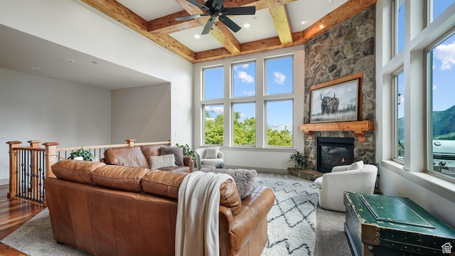 740 S Oak Dr, Woodland Hills, UT 84653 - living area featuring a stone fireplace, plenty of natural light, a ceiling fan, beamed ceiling, and a towering ceiling