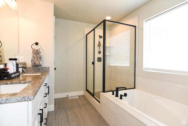 581 W 2030 N Unit 19A, Tooele, UT 84074 - bathroom featuring a stall shower, a garden tub, double vanity, baseboards, and recessed lighting