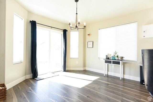 581 W 2030 N Unit 19A, Tooele, UT 84074 - unfurnished dining area featuring a chandelier, wood finished floors, and baseboards