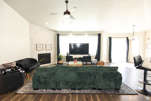 581 W 2030 N Unit 19A, Tooele, UT 84074 - living room with a tile fireplace, wood finished floors, ceiling fan, and a chandelier