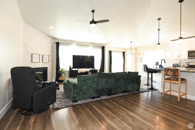 581 W 2030 N Unit 19A, Tooele, UT 84074 - living area featuring healthy amount of natural light, a ceiling fan, dark wood finished floors, a tile fireplace, and recessed lighting