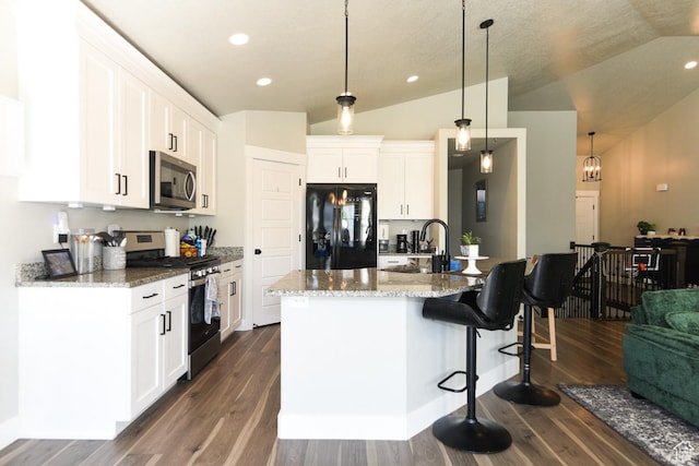581 W 2030 N Unit 19A, Tooele, UT 84074 - kitchen with appliances with stainless steel finishes, a kitchen breakfast bar, lofted ceiling, dark wood-style flooring, and white cabinetry