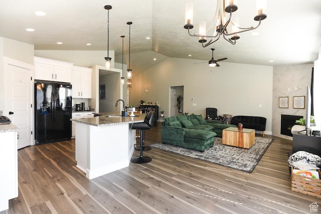 581 W 2030 N Unit 19A, Tooele, UT 84074 - kitchen featuring black fridge, open floor plan, ceiling fan, a sink, and lofted ceiling