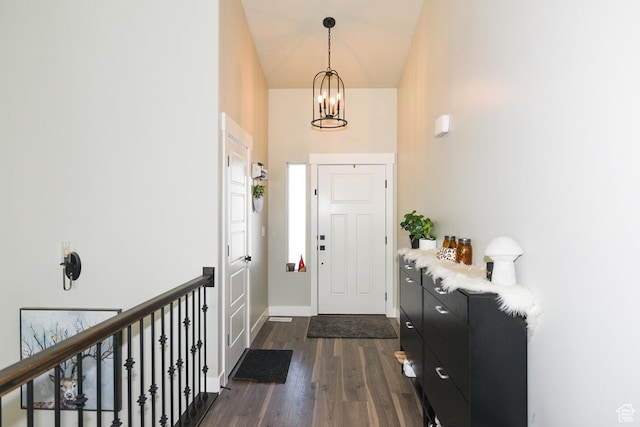 581 W 2030 N Unit 19A, Tooele, UT 84074 - foyer entrance featuring a towering ceiling, dark wood-style flooring, a chandelier, and baseboards