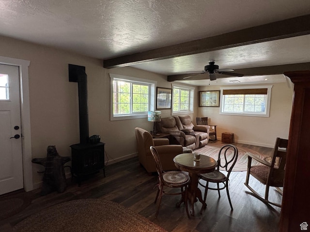 46 Alder Ct Unit 638, Fish Haven, ID 83287 - dining room with baseboards, beamed ceiling, wood finished floors, a wood stove, and a textured ceiling