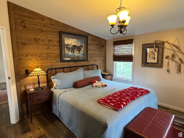 46 Alder Ct Unit 638, Fish Haven, ID 83287 - bedroom with a chandelier, dark wood finished floors, vaulted ceiling, wood walls, and baseboards