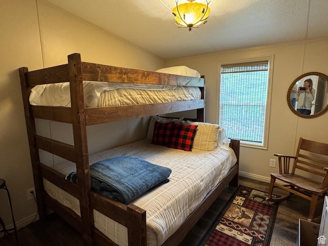 46 Alder Ct Unit 638, Fish Haven, ID 83287 - bedroom featuring wood finished floors, vaulted ceiling, a textured ceiling, and baseboards