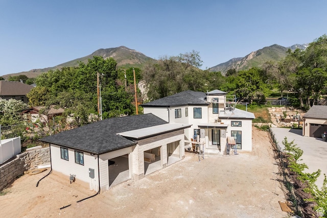 3685 S Craig Cir E, Millcreek, UT 84109 - rear view of house with a mountain view, a garage, and a shingled roof