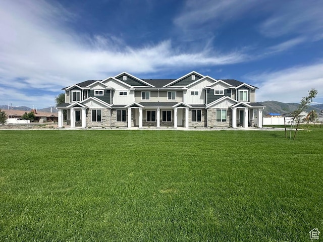 2205 S 1120 W Unit 62, Nibley, UT 84321 - view of front of house featuring stone siding, board and batten siding, a mountain view, and a porch