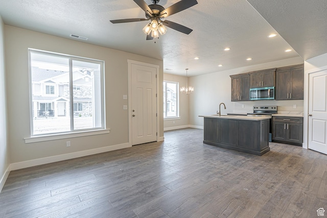 2205 S 1120 W Unit 62, Nibley, UT 84321 - kitchen featuring appliances with stainless steel finishes, recessed lighting, a textured ceiling, a chandelier, and baseboards