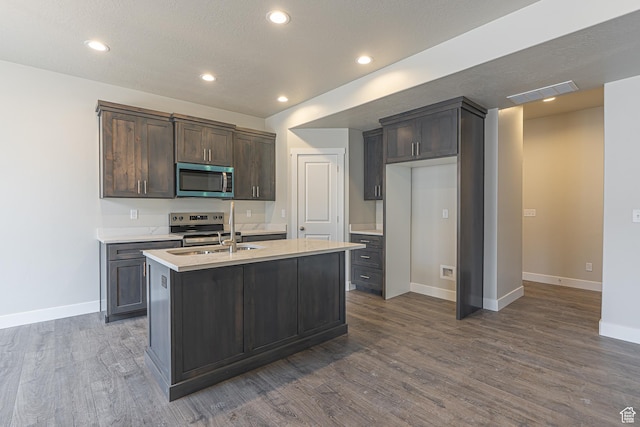 2205 S 1120 W Unit 62, Nibley, UT 84321 - kitchen featuring appliances with stainless steel finishes, a sink, dark wood-style flooring, light countertops, and dark brown cabinets