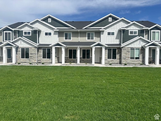 2205 S 1120 W Unit 62, Nibley, UT 84321 - view of front facade featuring board and batten siding, stone siding, and a front lawn