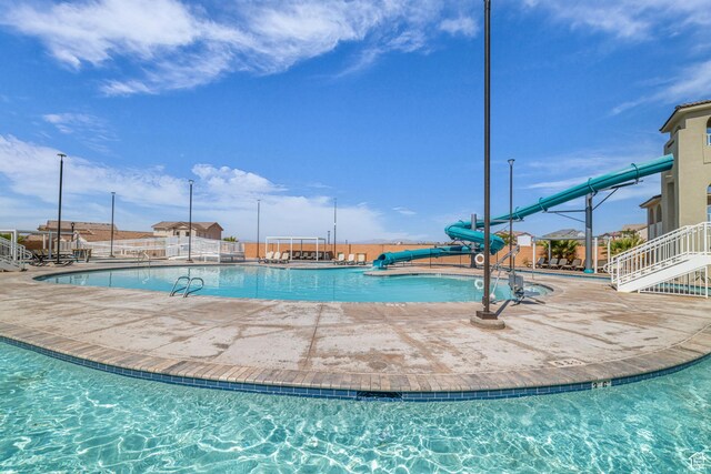 1189 N Bello Aly, Washington, UT 84780 - community pool with a water slide and a patio area