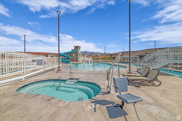 1189 N Bello Aly, Washington, UT 84780 - community pool with a hot tub, a patio, and a water slide