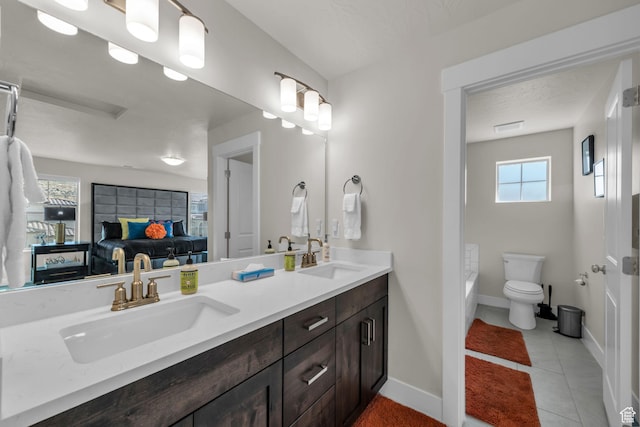 1189 N Bello Aly, Washington, UT 84780 - ensuite bathroom with double vanity, toilet, baseboards, a bathtub, and tile patterned floors