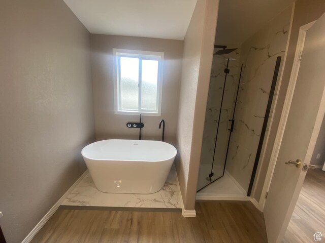 43 E 300 N, Duchesne, UT 84021 - bathroom featuring a marble finish shower, a freestanding bath, and wood finished floors