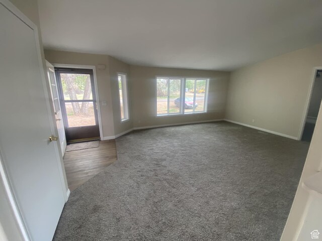 43 E 300 N, Duchesne, UT 84021 - unfurnished living room featuring healthy amount of natural light, carpet flooring, and baseboards