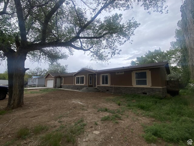 43 E 300 N, Duchesne, UT 84021 - ranch-style house with a garage, stone siding, and dirt driveway