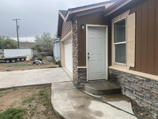 43 E 300 N, Duchesne, UT 84021 - entrance to property with stone siding, an attached garage, and driveway