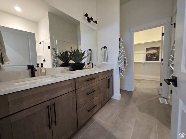 3564 W Haven Hollow Dr S, South Jordan, UT 84095 - full bath featuring double vanity, a walk in closet, baseboards, tile patterned floors, and a shower