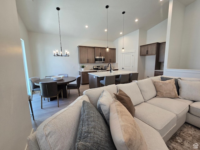3564 W Haven Hollow Dr S, South Jordan, UT 84095 - living area featuring a chandelier, wood finished floors, recessed lighting, and vaulted ceiling