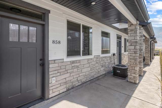 858 E 250 N, Hyrum, UT 84319 - view of exterior entry featuring central air condition unit and stone siding