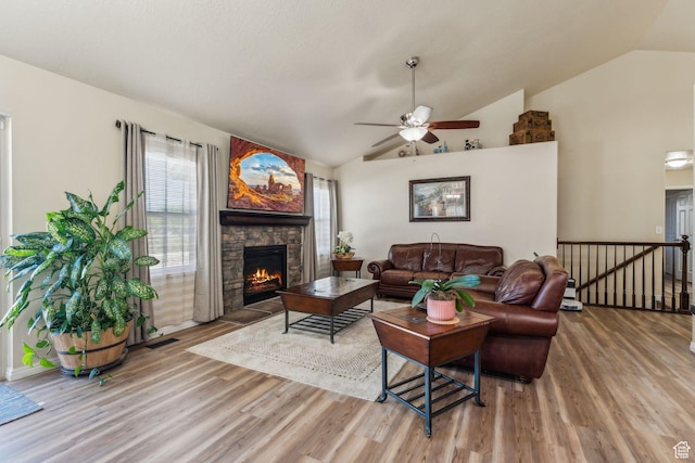 1044 S 1775 W, Syracuse, UT 84075 - living room featuring wood finished floors, lofted ceiling, a stone fireplace, and a ceiling fan
