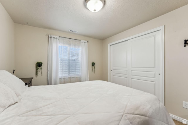 1044 S 1775 W, Syracuse, UT 84075 - bedroom with a closet, a textured ceiling, and baseboards