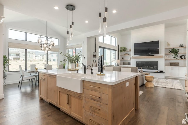 717 N Bridal Creek Ln E, Heber City, UT 84032 - kitchen featuring a sink, light brown cabinetry, dark wood finished floors, a glass covered fireplace, and pendant lighting