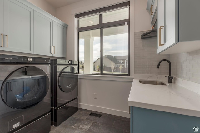 717 N Bridal Creek Ln E, Heber City, UT 84032 - washroom featuring cabinet space, separate washer and dryer, baseboards, and dark stone finish flooring