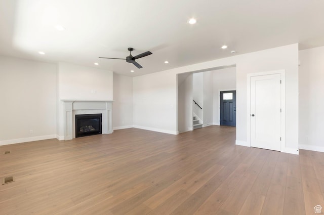2133 N 725 W, Centerville, UT 84014 - unfurnished living room with a ceiling fan, wood finished floors, stairs, recessed lighting, and baseboards