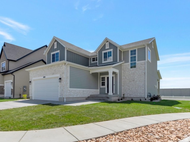 2133 N 725 W, Centerville, UT 84014 - view of front of house featuring stone siding, driveway, board and batten siding, and an attached garage