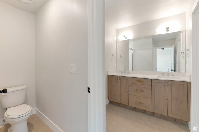 2133 N 725 W, Centerville, UT 84014 - bathroom with tile patterned floors, toilet, double vanity, and baseboards