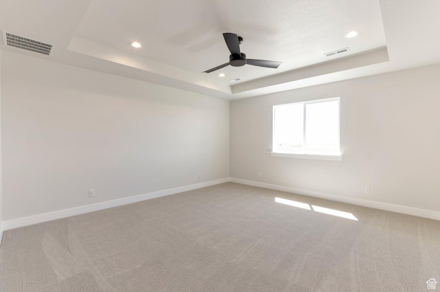 2133 N 725 W, Centerville, UT 84014 - spare room with a tray ceiling, ceiling fan, light colored carpet, baseboards, and recessed lighting