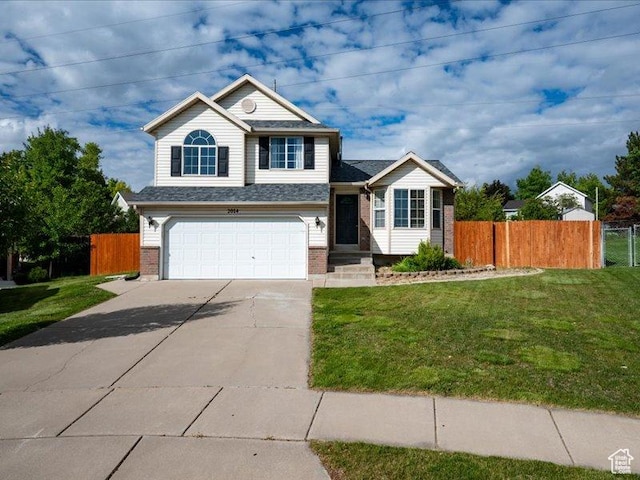 2014 S Jenny Ln, Clearfield, UT 84015 - view of front of house with an attached garage, brick siding, and driveway
