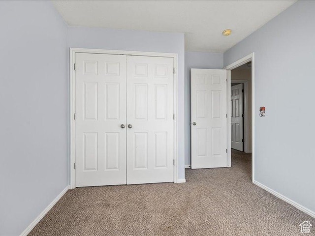 2014 S Jenny Ln, Clearfield, UT 84015 - unfurnished bedroom featuring carpet, a closet, and baseboards