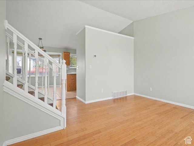2014 S Jenny Ln, Clearfield, UT 84015 - empty room featuring stairs, light wood finished floors, baseboards, and vaulted ceiling