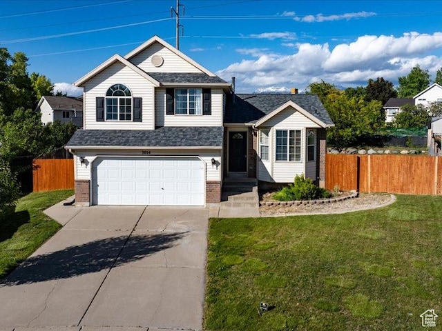 2014 S Jenny Ln, Clearfield, UT 84015 - view of front of home with an attached garage, brick siding, concrete driveway, and a shingled roof