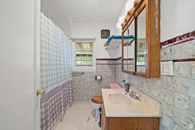 960 Patterson St, Ogden, UT 84403 - full bath featuring toilet, vanity, tile patterned flooring, a wainscoted wall, and a shower with curtain
