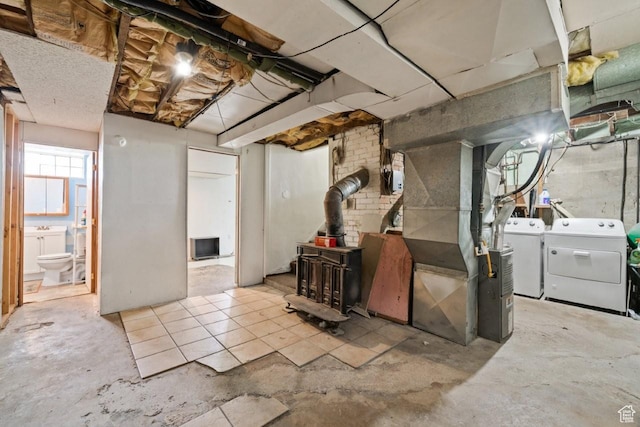 960 Patterson St, Ogden, UT 84403 - basement with washing machine and clothes dryer, a wood stove, and heating unit