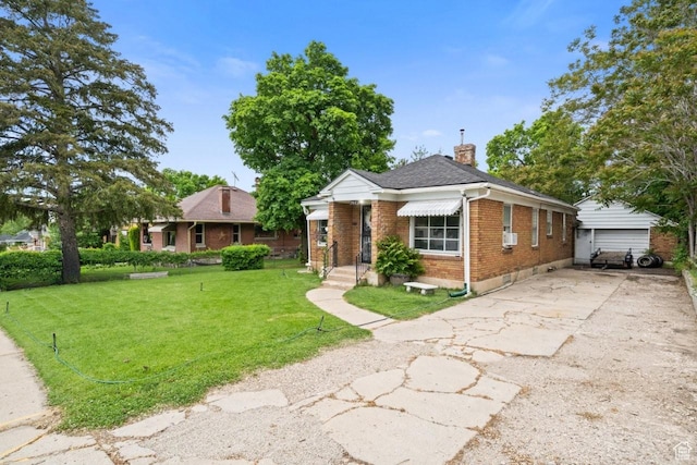 960 Patterson St, Ogden, UT 84403 - view of front of home with brick siding, a chimney, a front yard, and a shingled roof