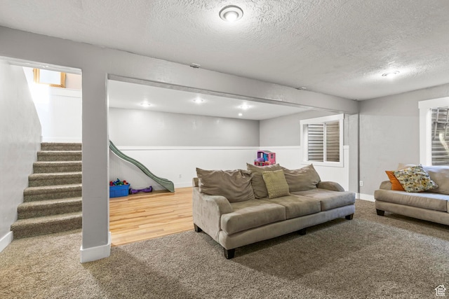 1933 N 120 W, Tooele, UT 84074 - carpeted living area with a textured ceiling, stairs, and baseboards