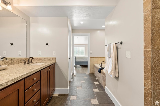 1933 N 120 W, Tooele, UT 84074 - full bathroom featuring baseboards, vanity, stone tile flooring, ensuite bathroom, and recessed lighting
