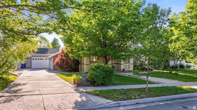 1933 N 120 W, Tooele, UT 84074 - view of property hidden behind natural elements featuring a front lawn, concrete driveway, and an attached garage