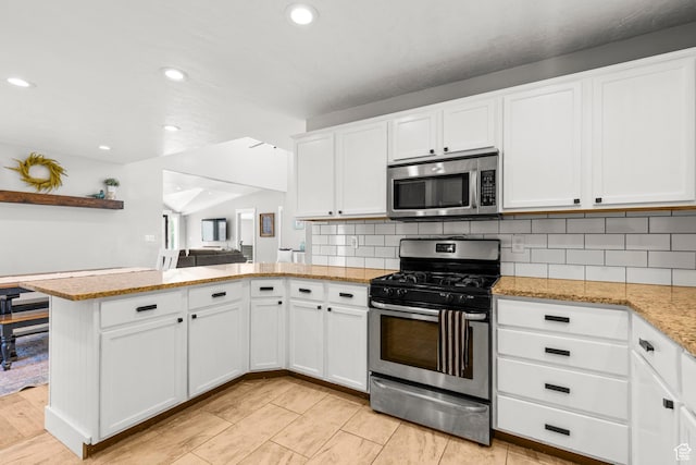1933 N 120 W, Tooele, UT 84074 - kitchen with stainless steel appliances, a peninsula, white cabinets, backsplash, and recessed lighting