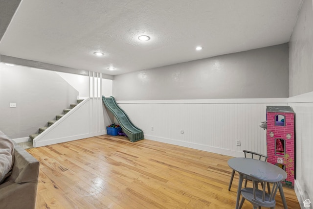 1933 N 120 W, Tooele, UT 84074 - game room with a wainscoted wall, wood finished floors, a textured ceiling, recessed lighting, and baseboards