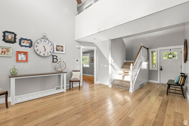1933 N 120 W, Tooele, UT 84074 - entrance foyer featuring stairs, light wood finished floors, baseboards, and a towering ceiling